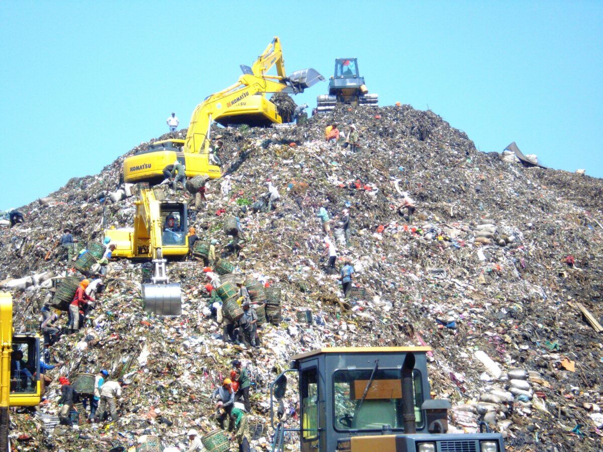 Mountain of garbage in bantar gebang with some excavator scaled